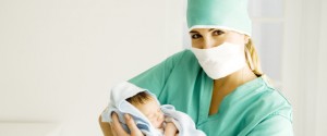 A medical practitioner holding a newborn baby