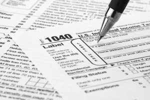 Tax form being filled out.  1040, advisor, april, balance, bill, budget, business, confusion, deductions, document, filing, finance, financial, form, government, horizontal, income, nobody, number, paper, paperwork, pen, refund, tax, taxes, wages.  Shutterstock 65341252